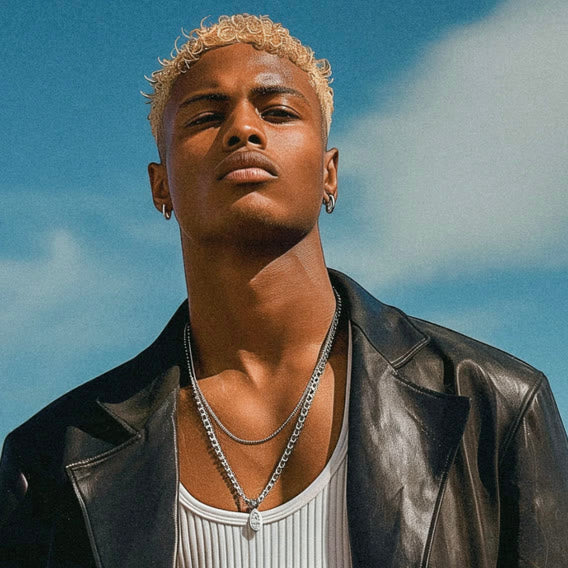 Man in a leather jacket wearing layered silver chains